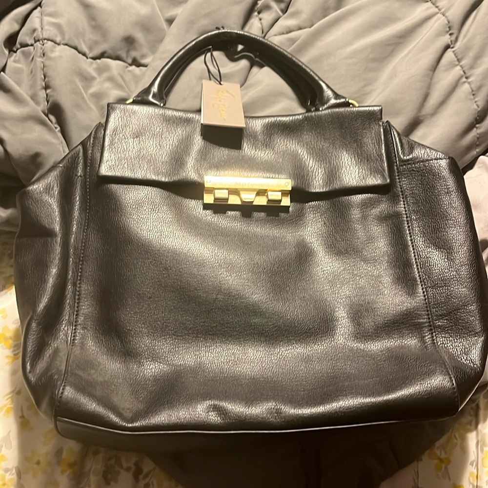 Mint new with tags, Foley and Corina leather bag including duster bag. Like new